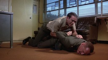 Movie still from “The Great Santini” (1979), directed by Lewis John Carlino – Two men are wrestling on the floor of a living room; Medium shot, High angle