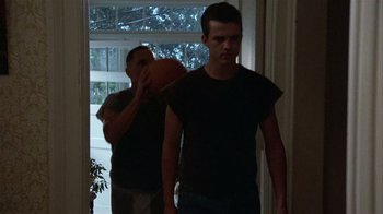 Movie still from “The Great Santini” (1979), directed by Lewis John Carlino – Two young men standing next to each other in front of a window; Medium shot, Low angle