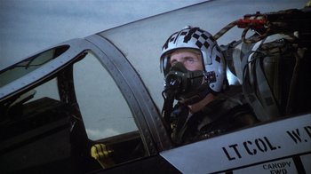 Movie still from “The Great Santini” (1979), directed by Lewis John Carlino – A man in a fighter pilot's helmet sitting in an airplane; Medium shot, Low angle
