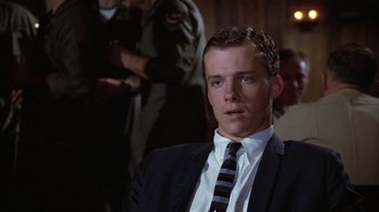 Movie still from “The Great Santini” (1979), directed by Lewis John Carlino – A man wearing a suit and tie in front of a crowd; Close Up shot, Low angle