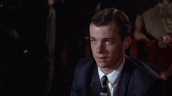 Movie still from “The Great Santini” (1979), directed by Lewis John Carlino – A man wearing a suit and tie sitting in a room; Close Up shot, Low angle