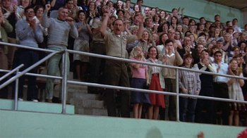 Movie still from “The Great Santini” (1979), directed by Lewis John Carlino – A group of people standing in front of an audience; Wide shot, High angle