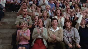 Movie still from “The Great Santini” (1979), directed by Lewis John Carlino – A group of people sitting and standing in front of each other; Medium shot, High angle