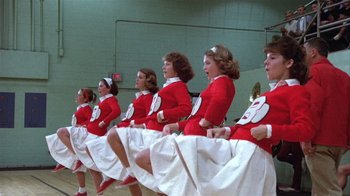 Movie still from “The Great Santini” (1979), directed by Lewis John Carlino – A group of young women in red and white dresses; Wide shot, Low angle