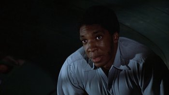 Movie still from “The Great Santini” (1979), directed by Lewis John Carlino – A man in a blue dress shirt looking at the camera; Close Up shot, Low angle