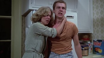 Movie still from “The Great Santini” (1979), directed by Lewis John Carlino – A man and a woman in a kitchen; Medium shot, Low angle