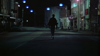 Movie still from “The Great Santini” (1979), directed by Lewis John Carlino – A person walking down a street at night; Wide shot, Low angle