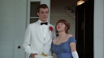Movie still from “The Great Santini” (1979), directed by Lewis John Carlino – A man and a woman dressed in formal wear; Medium shot, Low angle