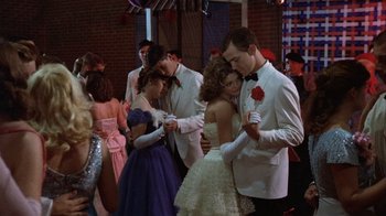 Movie still from “The Great Santini” (1979), directed by Lewis John Carlino – A group of young people dressed in formal attire; Medium shot, Over the shoulder angle