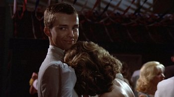 Movie still from “The Great Santini” (1979), directed by Lewis John Carlino – A man and a woman are smiling for the camera; Close Up shot, Low angle