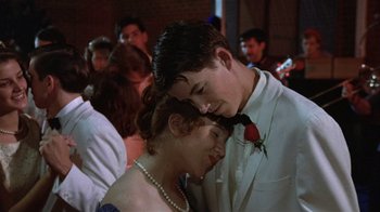 Movie still from “The Great Santini” (1979), directed by Lewis John Carlino – A man and a woman in formal wear standing next to each other; Medium shot, Over the shoulder angle