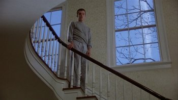 Movie still from “The Great Santini” (1979), directed by Lewis John Carlino – A man standing on the bottom of the stairs; Wide shot, Low angle