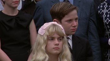 Movie still from “The Great Santini” (1979), directed by Lewis John Carlino – A girl and a boy are standing next to each other; Close Up shot, Low angle