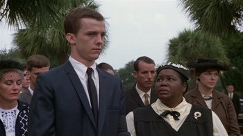 Movie still from “The Great Santini” (1979), directed by Lewis John Carlino – A group of people standing next to each other; Medium shot, Low angle