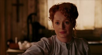 Movie still from “The Greatest Game Ever Played” (2005), directed by Bill Paxton – A person with curly red hair; Close Up shot, Over the shoulder angle