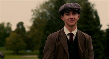 Movie still from “The Greatest Game Ever Played” (2005), directed by Bill Paxton – A young man in a suit and a hat; Close Up shot, Over the shoulder angle