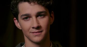 Movie still from “The Greatest Game Ever Played” (2005), directed by Bill Paxton – A young man's face with green eyes; Close Up shot, Over the shoulder angle