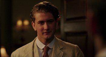 Movie still from “The Greatest Game Ever Played” (2005), directed by Bill Paxton – A young man in a suit and a tie; Close Up shot, Low angle