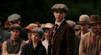 Movie still from “The Greatest Game Ever Played” (2005), directed by Bill Paxton – A group of young men in hats and suits; Medium shot, Over the shoulder angle
