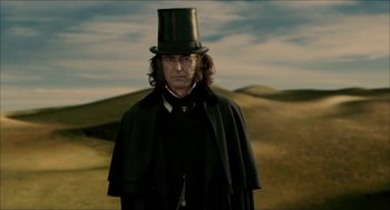 Movie still from “The Greatest Game Ever Played” (2005), directed by Bill Paxton – A man wearing a top hat and a black cape; Medium shot, Low angle