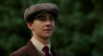 Movie still from “The Greatest Game Ever Played” (2005), directed by Bill Paxton – A young man wearing a hat and a tie; Close Up shot, Low angle