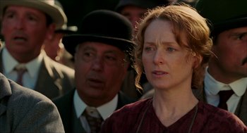 Movie still from “The Greatest Game Ever Played” (2005), directed by Bill Paxton – A woman in a red dress and a man in a black hat; Close Up shot, Over the shoulder angle