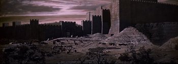 Movie still from “The Greatest Story Ever Told” (1965), directed by David Lean – A large stone castle with a lot of people in it; Extreme Wide shot, High angle