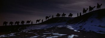 Movie still from “The Greatest Story Ever Told” (1965), directed by David Lean – A group of people riding horses on top of a hill; Extreme Wide shot, Low angle