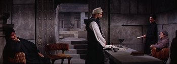 Movie still from “The Greatest Story Ever Told” (1965), directed by David Lean – A man standing in front of a stone wall; Wide shot, High angle