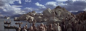 Movie still from “The Greatest Story Ever Told” (1965), directed by David Lean – A group of people on a boat in a body of water; Extreme Wide shot, High angle