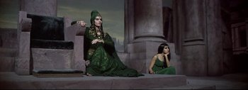 Movie still from “The Greatest Story Ever Told” (1965), directed by David Lean – Two women dressed in green sitting next to each other; Medium shot, High angle