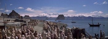Movie still from “The Greatest Story Ever Told” (1965), directed by David Lean – A group of people standing on top of a sandy beach; Extreme Wide shot, High angle