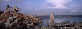 Movie still from “The Greatest Story Ever Told” (1965), directed by David Lean – A group of people on a boat in the water; Extreme Wide shot, High angle