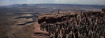 Movie still from “The Greatest Story Ever Told” (1965), directed by David Lean – A large group of people standing on top of a mountain; Extreme Wide shot, High angle