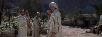 Movie still from “The Greatest Story Ever Told” (1965), directed by David Lean – A man in a white robe and a man in a white robe; Medium shot, Over the shoulder angle