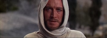 Movie still from “The Greatest Story Ever Told” (1965), directed by David Lean – A person wearing a hood; Close Up shot, Over the shoulder angle