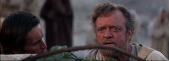 Movie still from “The Greatest Story Ever Told” (1965), directed by David Lean – An older man with a beard and mustache looking at the camera; Close Up shot, Low angle