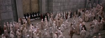 Movie still from “The Greatest Story Ever Told” (1965), directed by David Lean – A group of people dressed in white are gathered in a courtyard; Extreme Wide shot, High angle