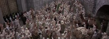 Movie still from “The Greatest Story Ever Told” (1965), directed by David Lean – A large group of people wearing white clothes and white hats; Extreme Wide shot, High angle