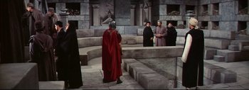 Movie still from “The Greatest Story Ever Told” (1965), directed by David Lean – A group of people standing around a building; Wide shot, High angle