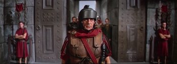 Movie still from “The Greatest Story Ever Told” (1965), directed by David Lean – An older man wearing a roman soldier's helmet; Medium shot, Low angle