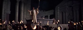 Movie still from “The Greatest Story Ever Told” (1965), directed by David Lean – A man holding a staff in the middle of an audience; Wide shot, Low angle