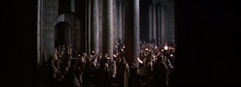 Movie still from “The Greatest Story Ever Told” (1965), directed by David Lean – A group of people standing in front of a pillar; Extreme Wide shot, High angle