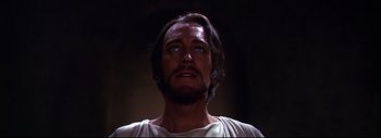 Movie still from “The Greatest Story Ever Told” (1965), directed by David Lean – A person with a beard looking up; Close Up shot, Low angle