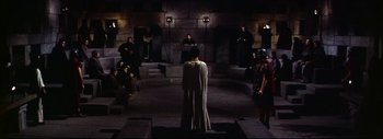 Movie still from “The Greatest Story Ever Told” (1965), directed by David Lean – A group of people sitting in a dark room; Extreme Wide shot, High angle