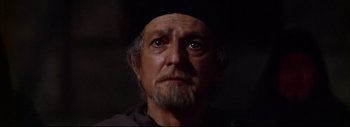 Movie still from “The Greatest Story Ever Told” (1965), directed by David Lean – An old man with a beard wearing a black hat; Close Up shot, Over the shoulder angle