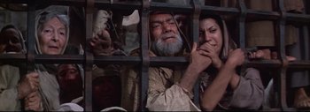 Movie still from “The Greatest Story Ever Told” (1965), directed by David Lean – A man and a woman looking out of a jail cell; Medium shot, High angle