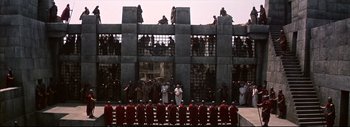 Movie still from “The Greatest Story Ever Told” (1965), directed by David Lean – A group of people standing in front of a building; Extreme Wide shot, High angle