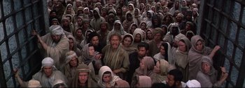 Movie still from “The Greatest Story Ever Told” (1965), directed by David Lean – A large group of people wearing head scarfs; Wide shot, High angle