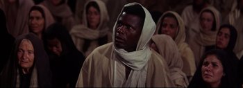 Movie still from “The Greatest Story Ever Told” (1965), directed by David Lean – A man in a white robe and a white head covering; Close Up shot, High angle